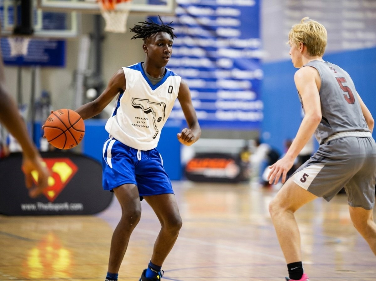 Point guard handling the ball at midcourt