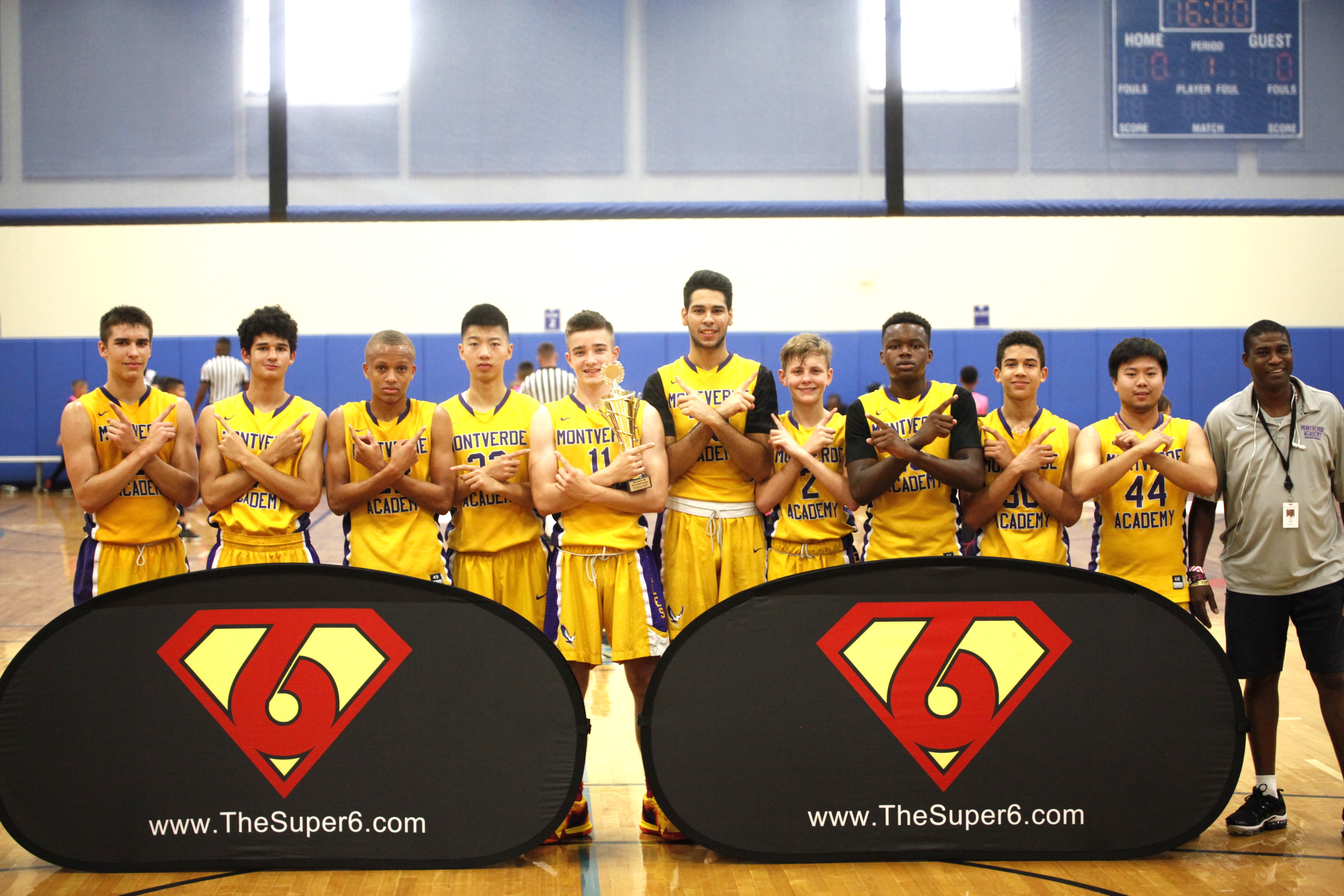 Montverde Academy team posed in front of Super6 banners