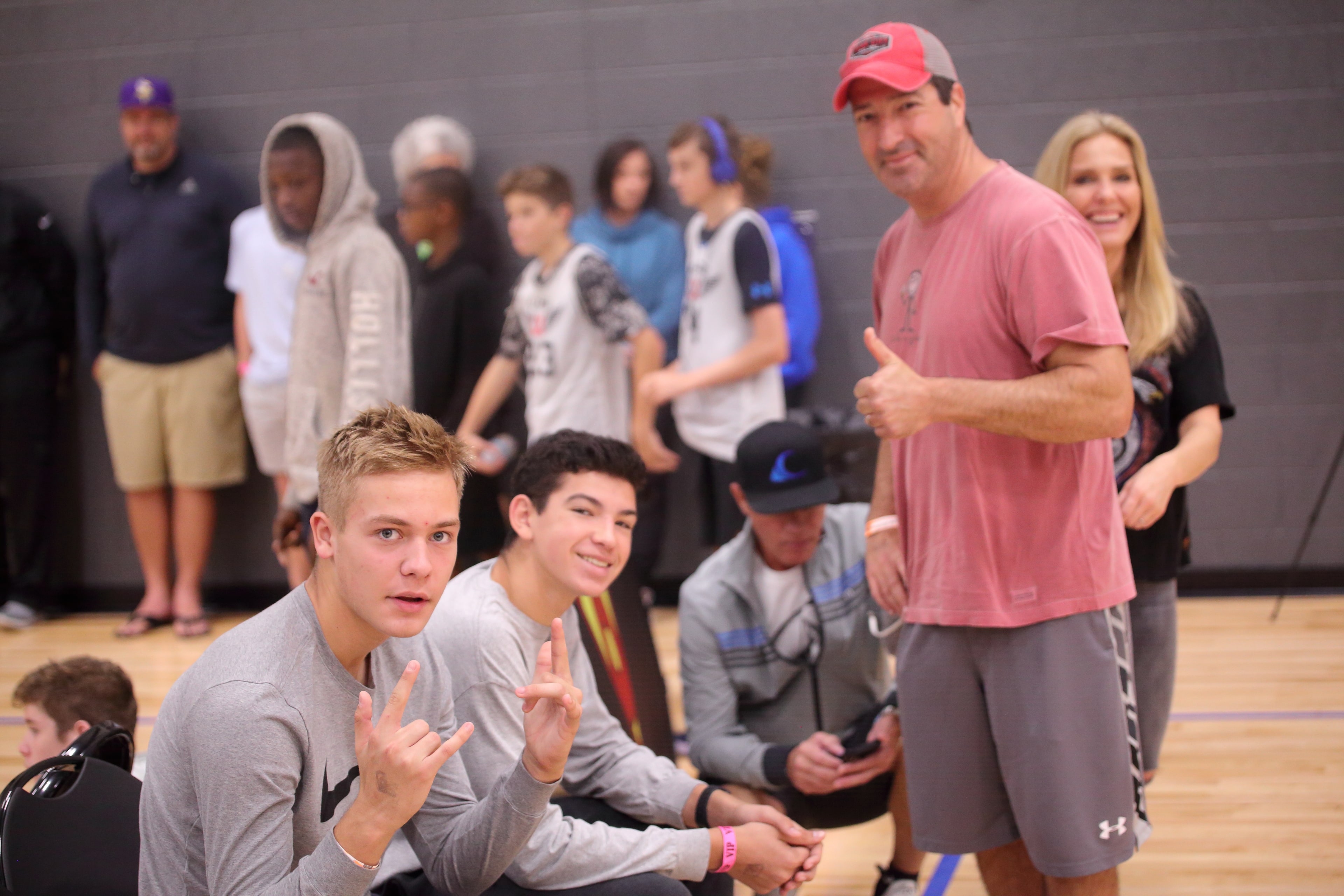 Young spectators flashing peace signs courtside