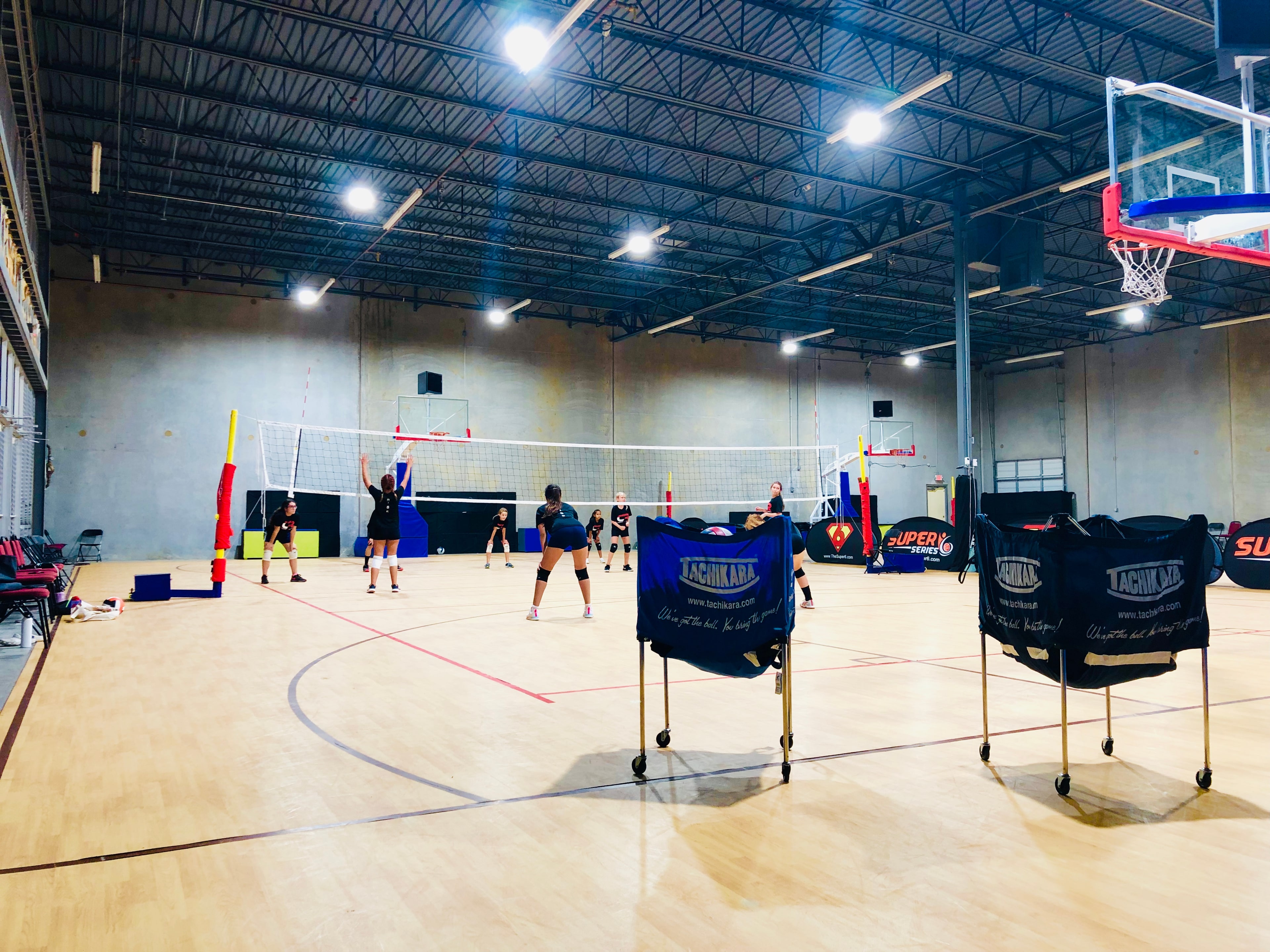 Wide shot of the finished multi-court facility with volleyball nets set up