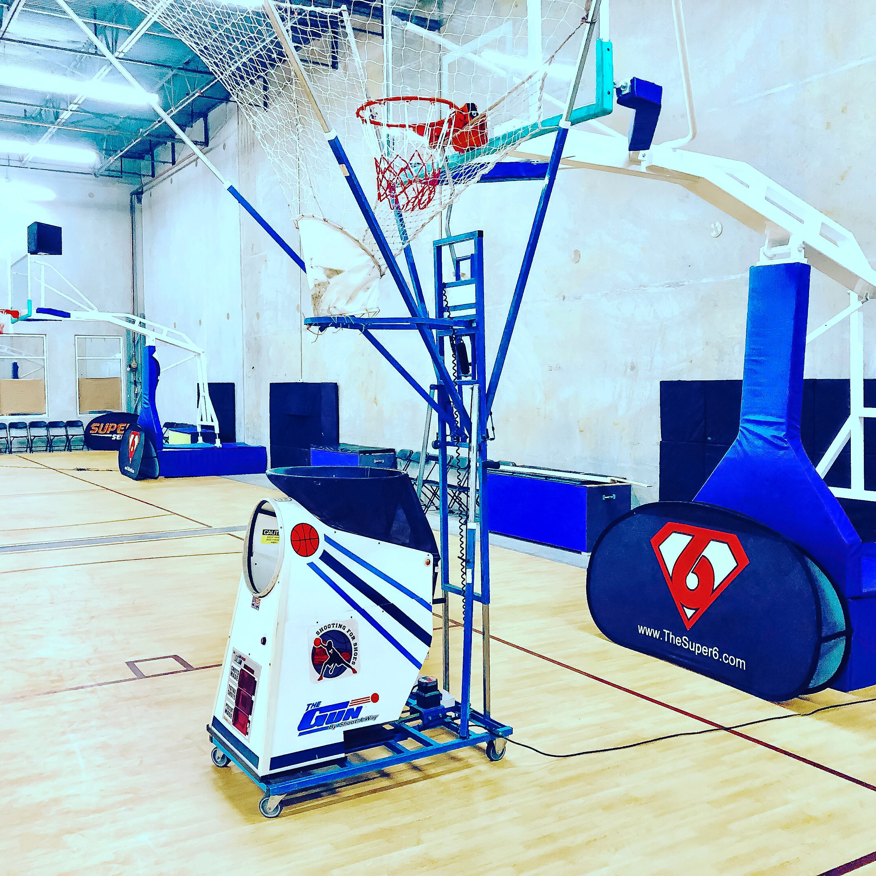 Finished Super6 Series facility with branded equipment, hoops, and shooting machine