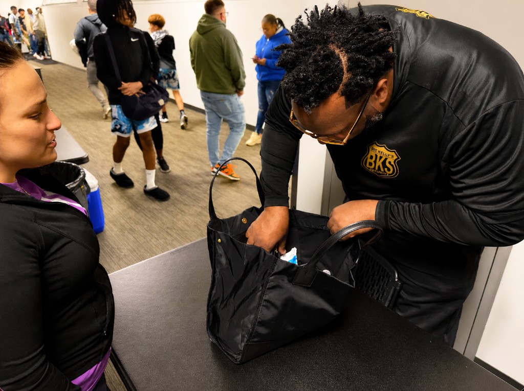 Security officer inspecting a bag at the venue entrance during a Super6 Series LLC tournament