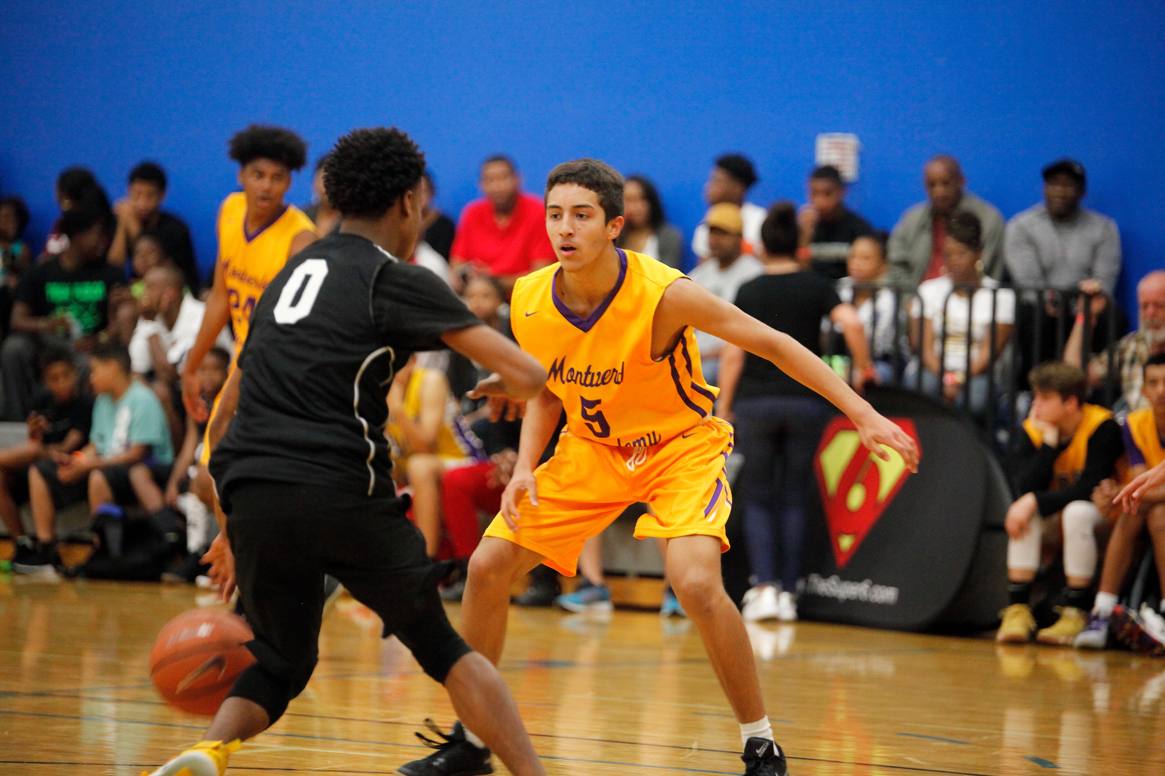 Youth basketball player in defensive stance during a Super6 Series LLC tournament