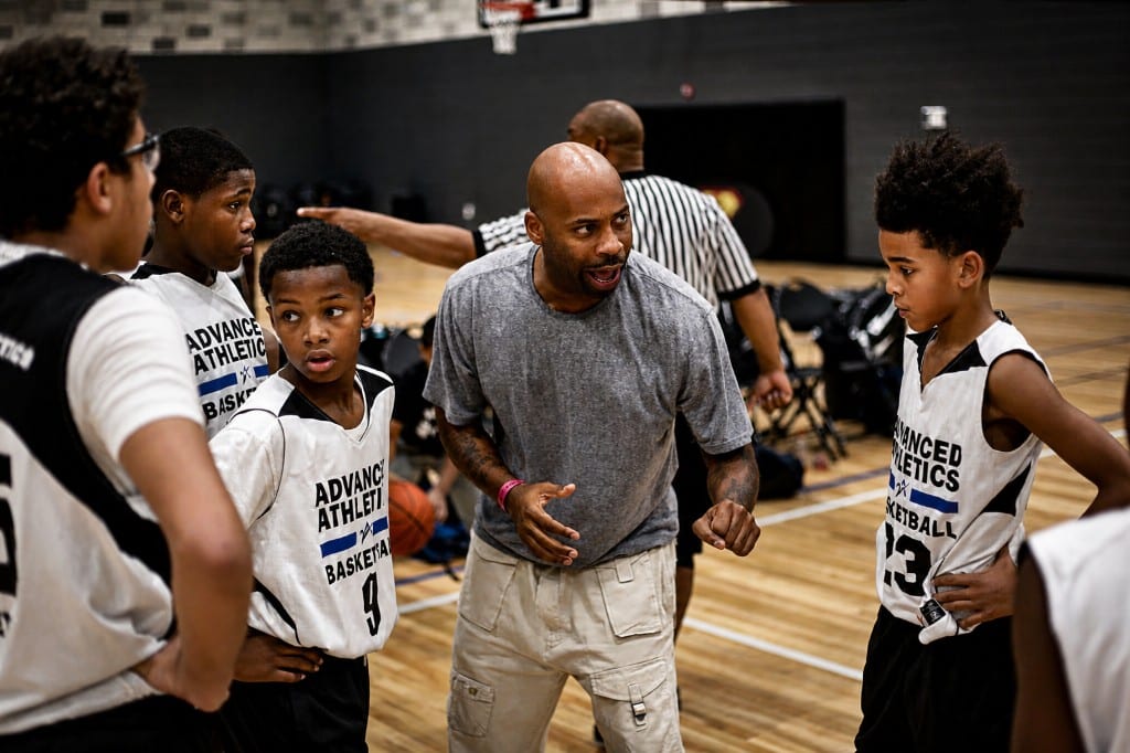 Coach addressing youth basketball players on the court