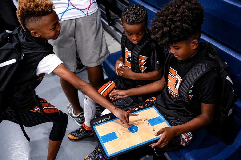 Youth players reviewing a tactics board together